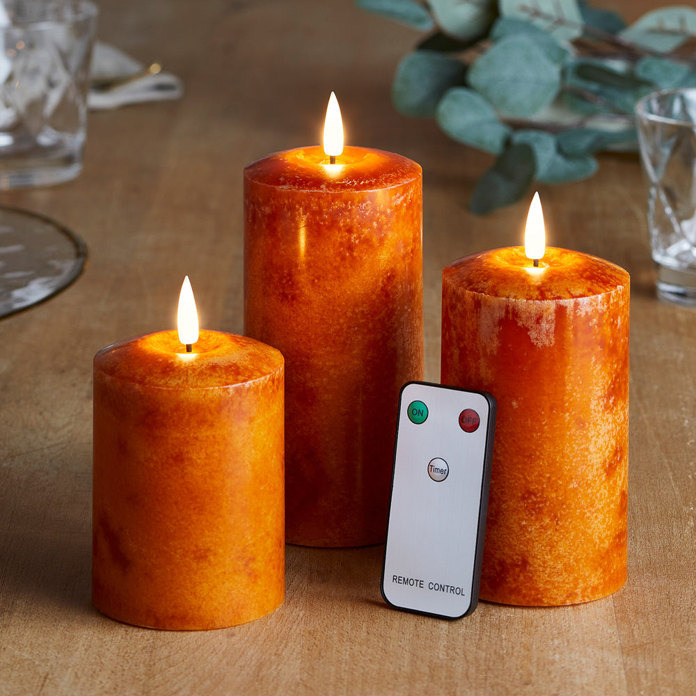 TruGlow® LED Echtwachskerzen Trio orange mit Fernbedienung