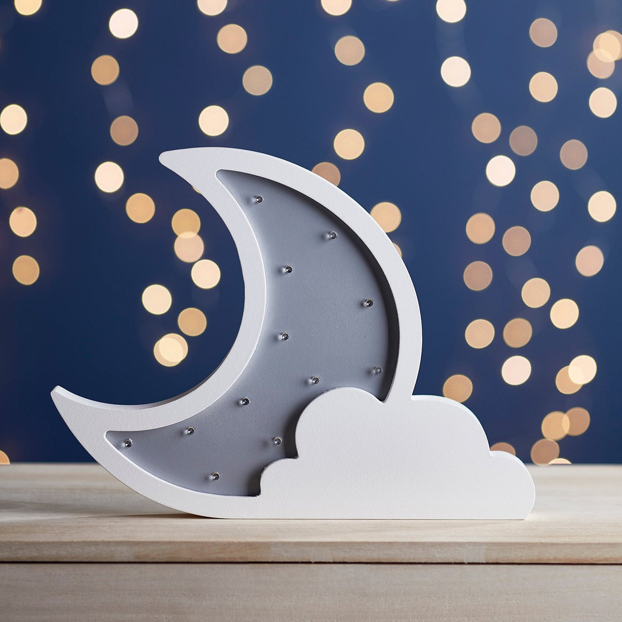 Mondlampe ausgeschaltet mit weißer Wolke vor dunkelblauem Hintergrund.